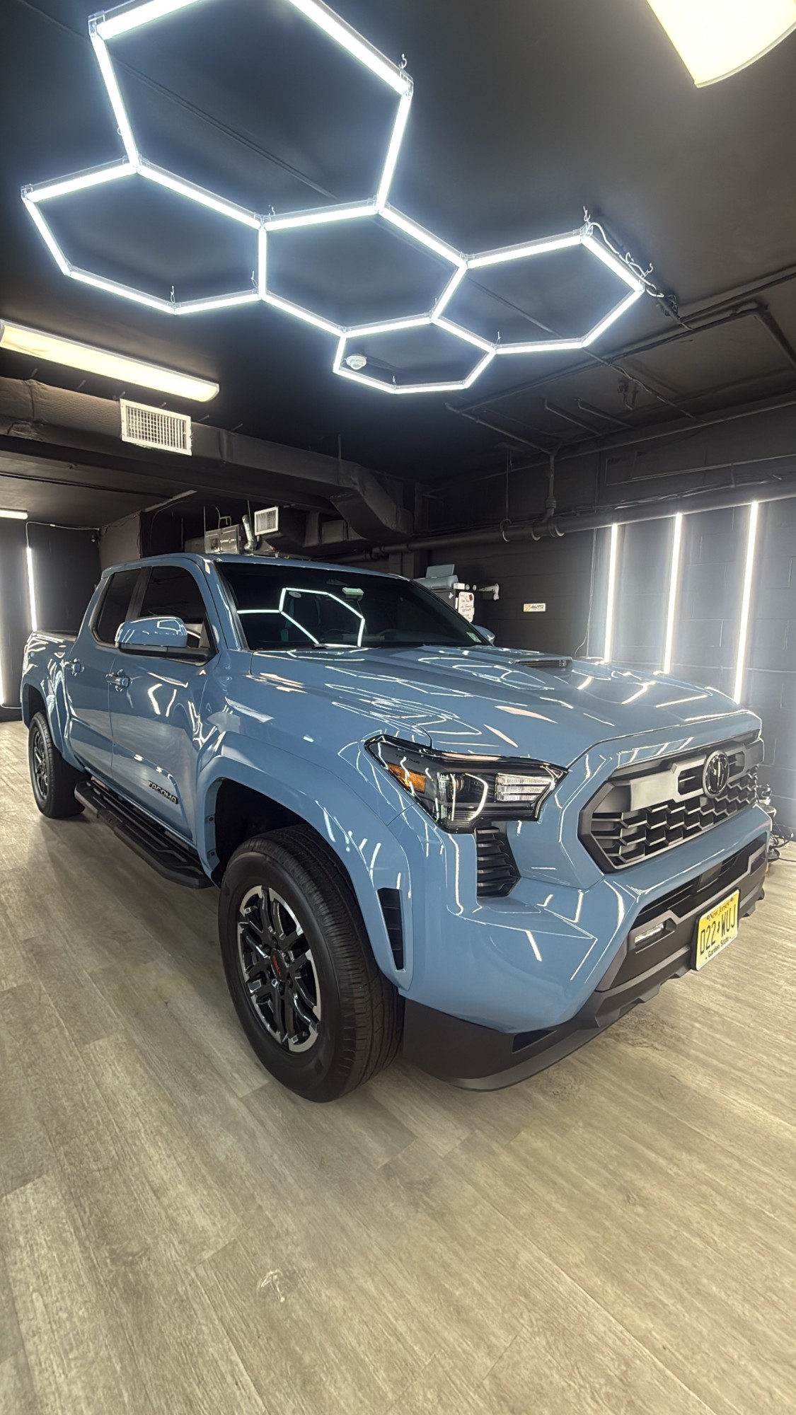 Toyota Tacoma finished with ceramic coating under the hexagon LED display at SB Auto Studio's Point Pleasant shop